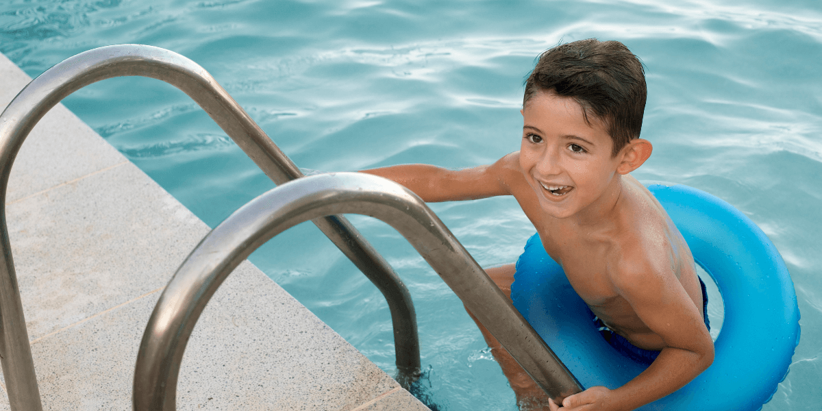 Child standing on the pool stairs